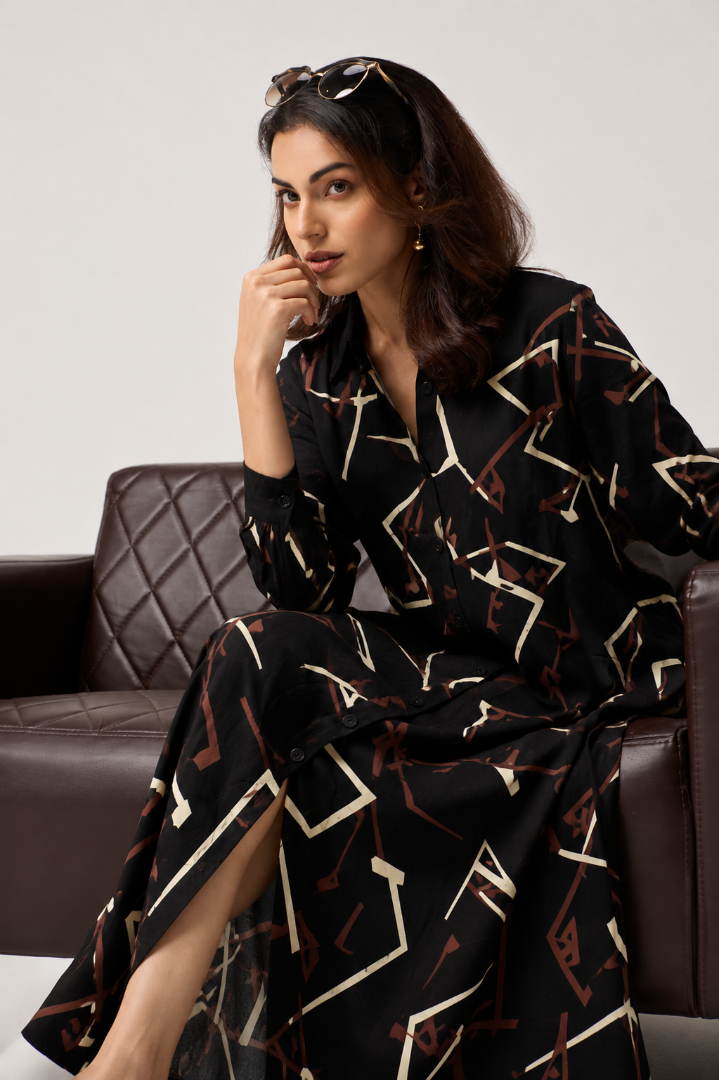 Serenaire Veloria Angular Workwear Dress in Black — seated on a sofa