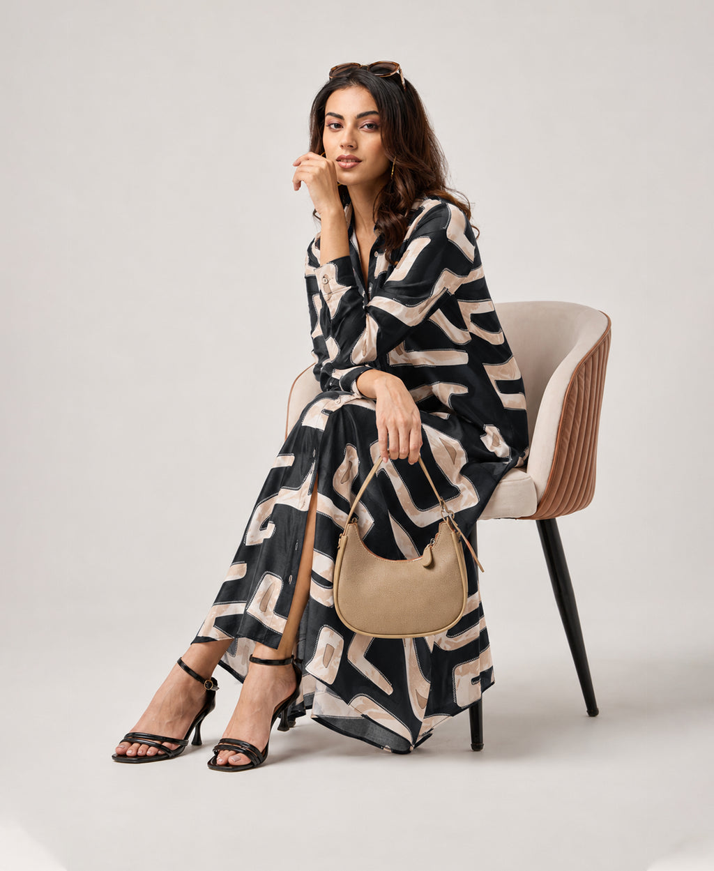 Serenaire Veloria Cutout Workwear Dress in Black — seated with bag