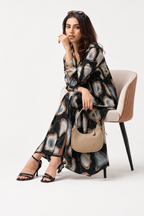 Serenaire Veloria Pebble Workwear Dress in Black — seated with bag